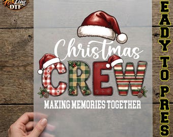 May include: A DTF transfer sheet featuring the text Christmas CREW and MAKING MEMORIES TOGETHER. The word CREW is styled with red and white buffalo plaid, green and tan plaid, solid red, and red and green striped patterns with Santa hats.