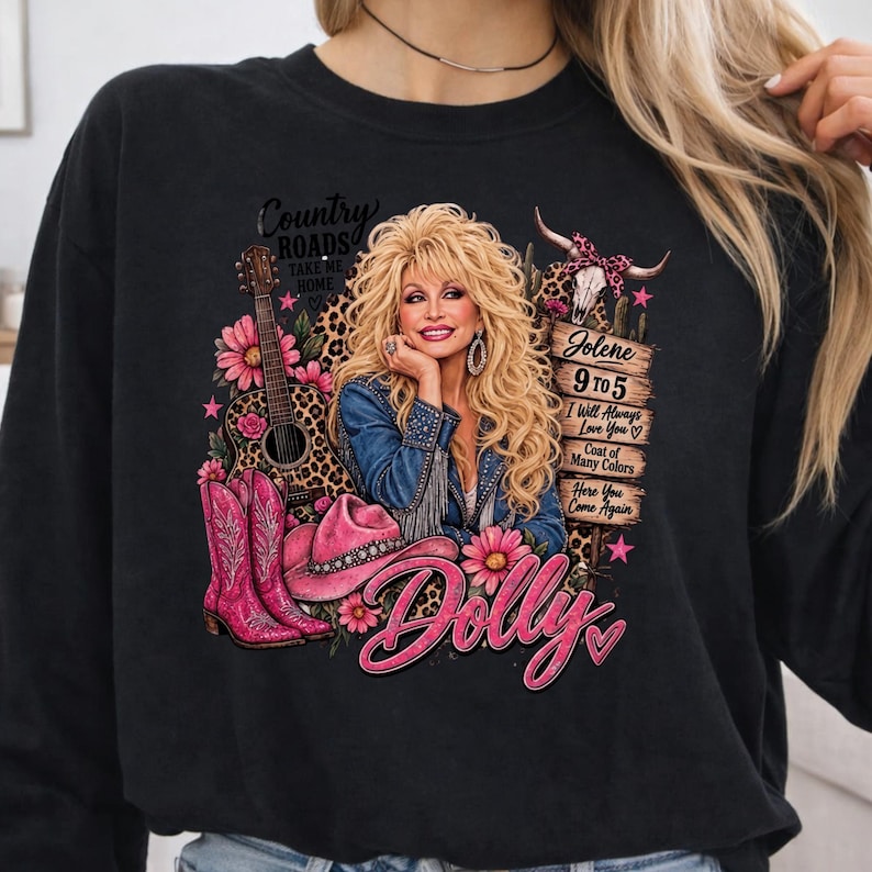 May include: A black long-sleeve sweatshirt featuring a graphic print of Dolly Parton with blonde hair, a denim jacket, a guitar, pink cowboy boots, a pink hat, and a wooden sign listing song titles like Jolene, 9 to 5, and I Will Always Love You.