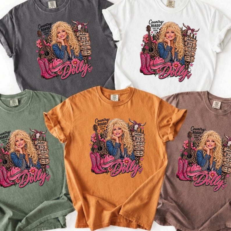 May include: A collection of five short-sleeve t-shirts in charcoal, white, olive green, mustard yellow, and brown. Each shirt features a graphic print of a blonde woman, a guitar, pink cowboy boots, a hat, and the text Dolly, Country Roads, and Jolene.
