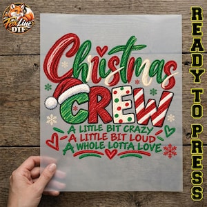 May include: A transparent DTF transfer sheet featuring the text Christmas Crew in red and green script and block lettering, accented by a Santa hat, candy cane stripes, and snowflakes. Below, the text reads A LITTLE BIT CRAZY A LITTLE BIT LOUD A WHOLE LOTTA LOVE.
