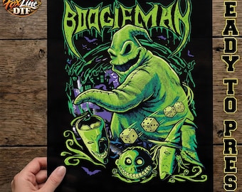 May include: A black DTF transfer sheet featuring a green graphic of the Boogieman character with the text BOOGIEMAN at the top. The design includes three white dice, a green mask, a round green face, and a green pointed hat on a black background.