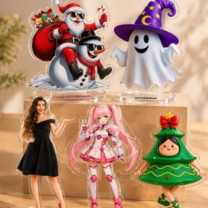 May include: Five acrylic standees featuring diverse characters: Santa Claus with a snowman, a ghost in a purple wizard hat, a woman in a black dress, an anime-style character named Lumina, and a person in a Christmas tree costume.