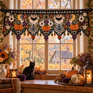 May include: A black crocheted window valance featuring intricate spider web patterns, orange pumpkins, yellow crescent moons, and colorful floral accents. The decorative lace trim hangs from a dark curtain rod, displaying detailed needlework.