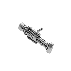 May include: Silver-toned metal nutcracker figurine door knob pull. The nutcracker is standing with a gun in one hand and a hat on his head.