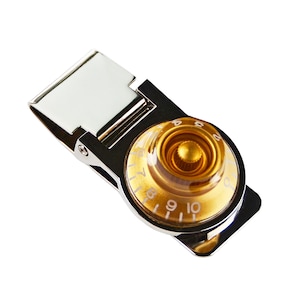 May include: A silver money clip with a gold-colored knob that has a clear plastic cover and white numbers 1-12 around the edge.