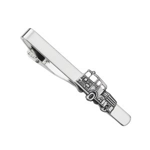 May include: Silver tie bar with a fire truck design.