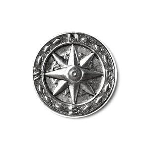 May include: A silver compass with a star-shaped design and the letters N, S, E, and W around the edge.