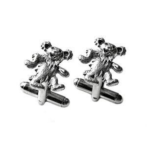 May include: A pair of silver cufflinks featuring a dancing bear design. The bear is depicted in a playful pose with its arms raised and legs spread.