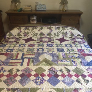 Queen bed quilt in purple, green, cream and blue