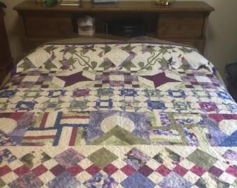 Queen bed quilt in purple, green, cream and blue