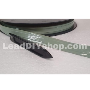 May include: A sage green flexible trim strip coiled on a black spool, accompanied by a black plastic installation tool. The text LeadDIYshop.com is printed across the center of the image. The trim has a smooth, glossy finish and a flat profile.