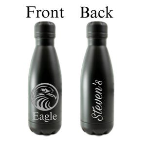 May include: A matte black metal water bottle featuring a circular eagle graphic and the word Eagle on the front, with the name Steven's written in a white script font on the back. The bottle has a rounded cap and a smooth, cylindrical body design.