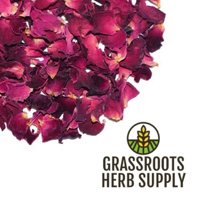 May include: A pile of dried rose petals, a natural ingredient for crafting and beauty products. The petals are a deep pink and red color, and they are scattered on a white background. The image also includes the logo for Grassroots Herb Supply.