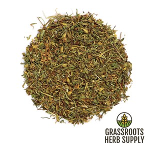 May include: A close-up of a pile of dried, green and brown herbs. The herbs are loose and scattered on a white background. The text "GRASSROOTS HERB SUPPLY" is visible in the lower right corner of the image.