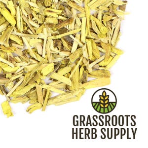 May include: Close-up of dried, yellow-toned herb pieces scattered on a white surface. The pieces vary in size and shape, with some appearing like small sticks. The image includes the text "GRASSROOTS HERB SUPPLY" with a logo of a wheat stalk.