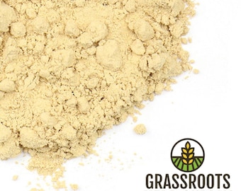 May include: A close-up of a pile of light yellow ginger powder. The powder is finely ground and has a smooth texture. The powder is on a white background. The image is from Grassroots Herb Supply.