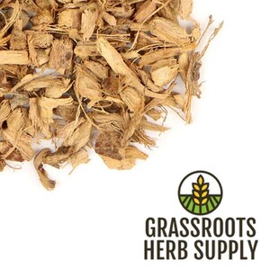 May include: Dried, light brown, shredded root bark.  The bark is in a pile on a white background.  The image includes the text "GRASSROOTS HERB SUPPLY".