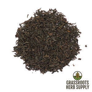 May include: Loose black tea leaves, a pile of dried tea leaves, ready to be brewed for a hot cup of tea.