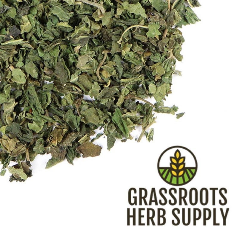 May include: Dried nettle leaves, a green herbal supplement, for use in teas, tinctures, or other herbal remedies.  Grassroots Herb Supply logo is visible in the lower right corner.