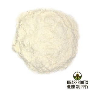 May include: A close-up view of a pile of off-white powder. The powder is finely ground and has a smooth texture.