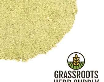 May include: A close-up of a pile of light green dried herb powder. The powder is finely ground and has a uniform texture. The powder is a natural product and is likely used for culinary or medicinal purposes.
