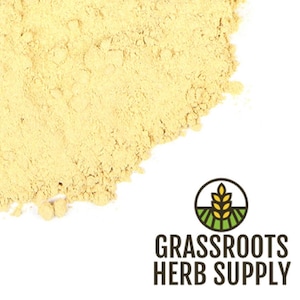 May include: A close-up of a pile of light yellow turmeric powder. The powder is finely ground and has a smooth texture. The powder is a popular spice used in cooking and has many health benefits.