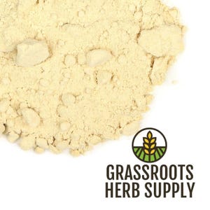 May include: Close-up of a pile of light beige powder with a granular texture. The powder is scattered on a white background. The logo for Grassroots Herb Supply is in the lower right corner.