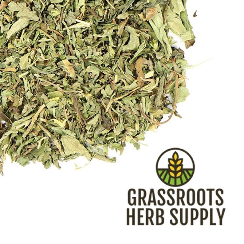 May include: Dried stevia leaves, a natural sweetener, in a pile on a white background. The image includes the text "GRASSROOTS HERB SUPPLY".