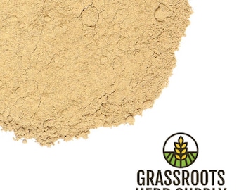May include: A close-up of a pile of light brown ginger powder. The powder is finely ground and has a slightly grainy texture.