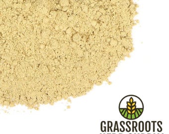 May include: A close-up of a pile of light brown ginger powder. The powder is finely ground and has a slightly grainy texture. The powder is a popular ingredient in cooking and baking.