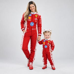 May include: Two matching red racing jumpsuits featuring white side stripes, high collars, and various sponsor logos including Ferrari, HP, IBM, and ZYN. The jumpsuits are paired with red racing shoes, and the smaller suit includes white hair bows.