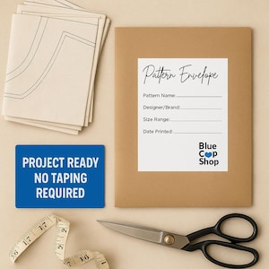 May include: A craft-themed image featuring a brown pattern envelope with a white label reading "Pattern Envelope." A blue sign says "PROJECT READY NO TAPING REQUIRED." Scissors, a measuring tape, and pattern pieces are also visible.