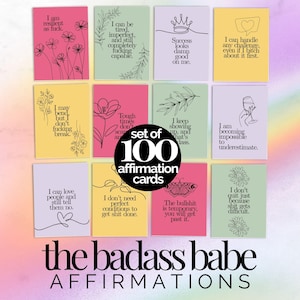 May include: A set of 100 affirmation cards featuring various pastel backgrounds including pink, yellow, green, and lavender. Each card displays unique motivational text and line art illustrations of flowers, crowns, butterflies, and wine glasses.