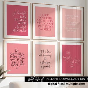 May include: Set of six printable pink and red motivational quotes with black text. The quotes include: "A beautiful day begins with a beautiful mindset", "Live for the moments you can't put into words", "Do something today that your future self will thank you for", "Fall in love with becoming the best version of yourself", "What you think you become, what you feel you attract, what you imagine you create", "Life is tough, they say, but so are you".