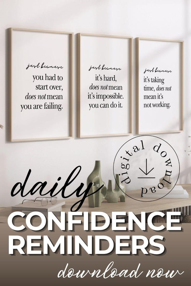 May include: Three framed prints with motivational quotes in black script. The prints are displayed above a wooden surface with decorative items. The words "daily CONFIDENCE REMINDERS" are also visible.