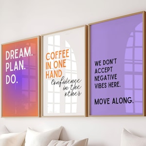 May include: Three motivational posters with inspirational quotes. The first poster is orange and purple with the text "DREAM. PLAN. DO.". The second poster is white with the text "COFFEE IN ONE HAND Confidence in the other". The third poster is purple with the text "WE DON'T ACCEPT NEGATIVE VIBES HERE. MOVE ALONG."