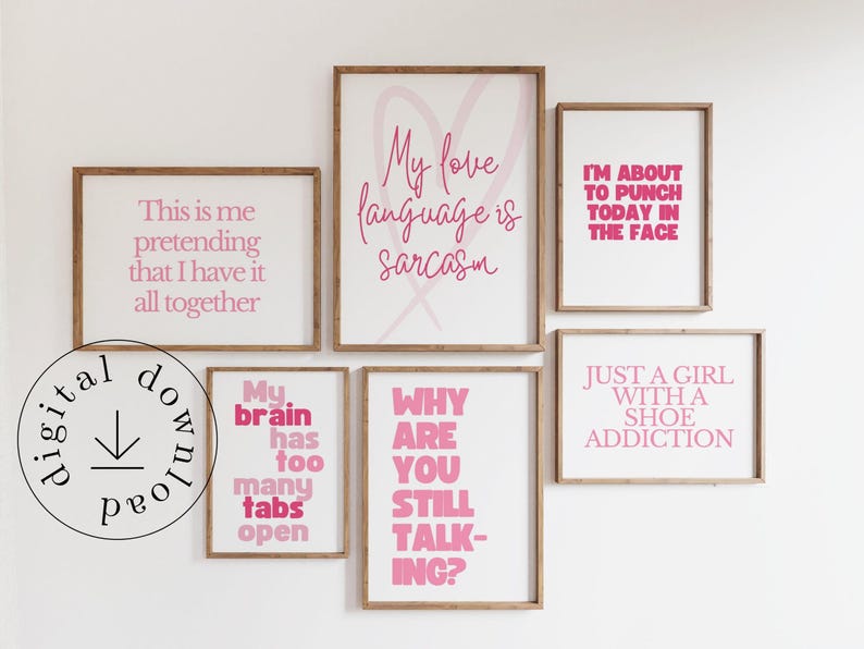May include: A collection of framed wall art with humorous quotes in pink lettering on a white background. The phrases include "My love language is sarcasm" and "Just a girl with a shoe addiction." The frames are a natural wood color.