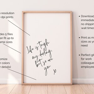 May include: A printable quote that reads "Life is tough, my darling, but so are you." The quote is framed in a light wood frame and is set against a white wall.