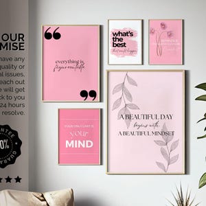 May include: A collection of framed art prints with inspirational quotes in pink and white. The prints include phrases like "Everything is figureoutable" and "A beautiful day begins with a beautiful mindset."