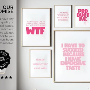 May include: A collection of framed art prints with humorous quotes in pink text on a white background. The prints include phrases like "WTF," "I have to succeed because I have expensive taste," and "I can make winging it look like a strategy."