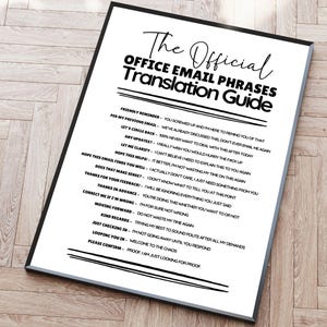 May include: A framed white poster with black text titled The Official Office Email Phrases Translation Guide. It lists common professional email phrases followed by their sarcastic interpretations, such as Friendly Reminder meaning you screwed up.