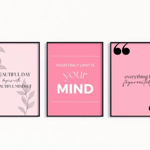 May include: Three framed art prints with motivational quotes. The prints feature pink backgrounds and black text. One says "A BEAUTIFUL DAY begins with A BEAUTIFUL MINDSET." Another says "YOUR ONLY LIMIT IS your MIND." The third says "everything is figureoutable."