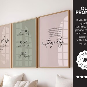 May include: Three framed wall art prints with inspirational quotes. The prints have a light brown wooden frame and a soft color palette of pink, green, and beige. The first print says "leadership", the second says "listen, speak, lead", and the third says "integrity".