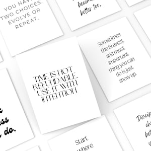 May include: A collection of white cards with black text featuring motivational quotes. The cards are arranged at various angles, creating a visually appealing display. The quotes include phrases like "Time is not refundable. Use it with intention."