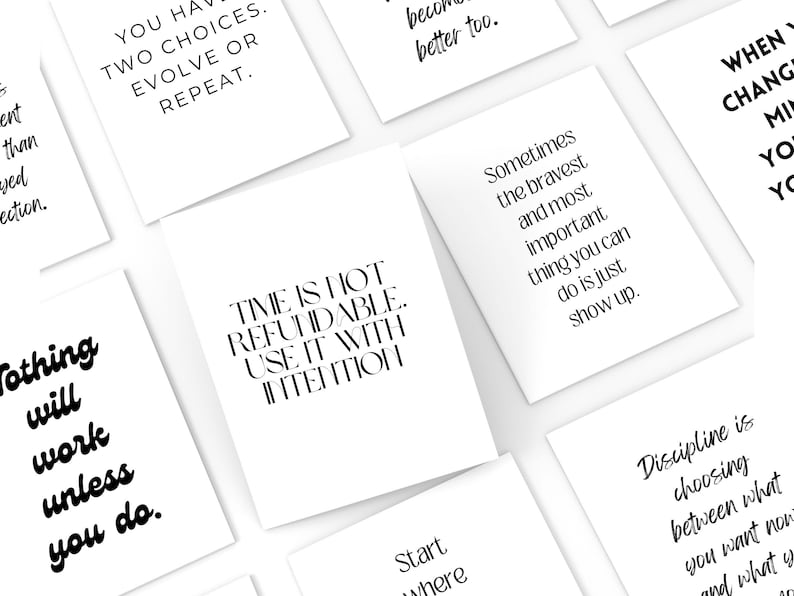 May include: A collection of white cards with black text featuring motivational quotes. The cards are arranged at various angles, creating a visually appealing display. The quotes include phrases like "Time is not refundable. Use it with intention."