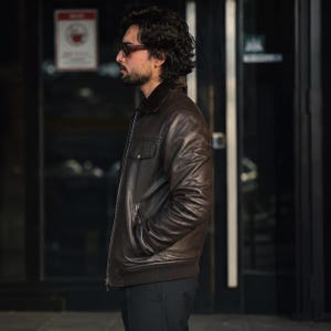 Side view of men's dark brown sheep leather bomber jacket with shearling collar