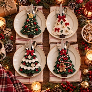 May include: Four cream-colored ceramic plates each holding a crochet Christmas tree utensil holder. The holders feature festive designs including a star, bows, snowflakes, and a gingerbread man, each containing a silver fork, knife, and spoon.