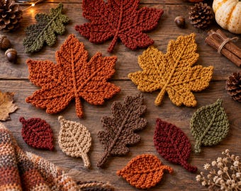 May include: A collection of crocheted autumn leaves in various shapes and colors, including deep red, burnt orange, golden yellow, brown, and olive green. The set features maple and oak leaf designs with visible yarn texture and intricate stitching.