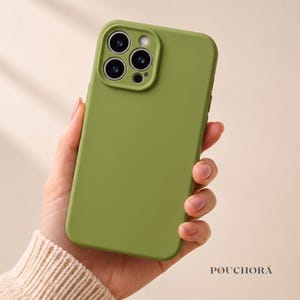 May include: A solid olive green smartphone case with a smooth matte finish, featuring a raised square camera cutout with three circular lens openings and a small flash aperture. The brand name POUCHORA is printed in black in the bottom corner.