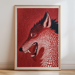 May include: A framed art print featuring a stylized wolf head in profile, rendered in a vibrant red and white dot-patterned technique. The wolf has an open mouth showing teeth, with black accents on the ears and snout, set against a red background.